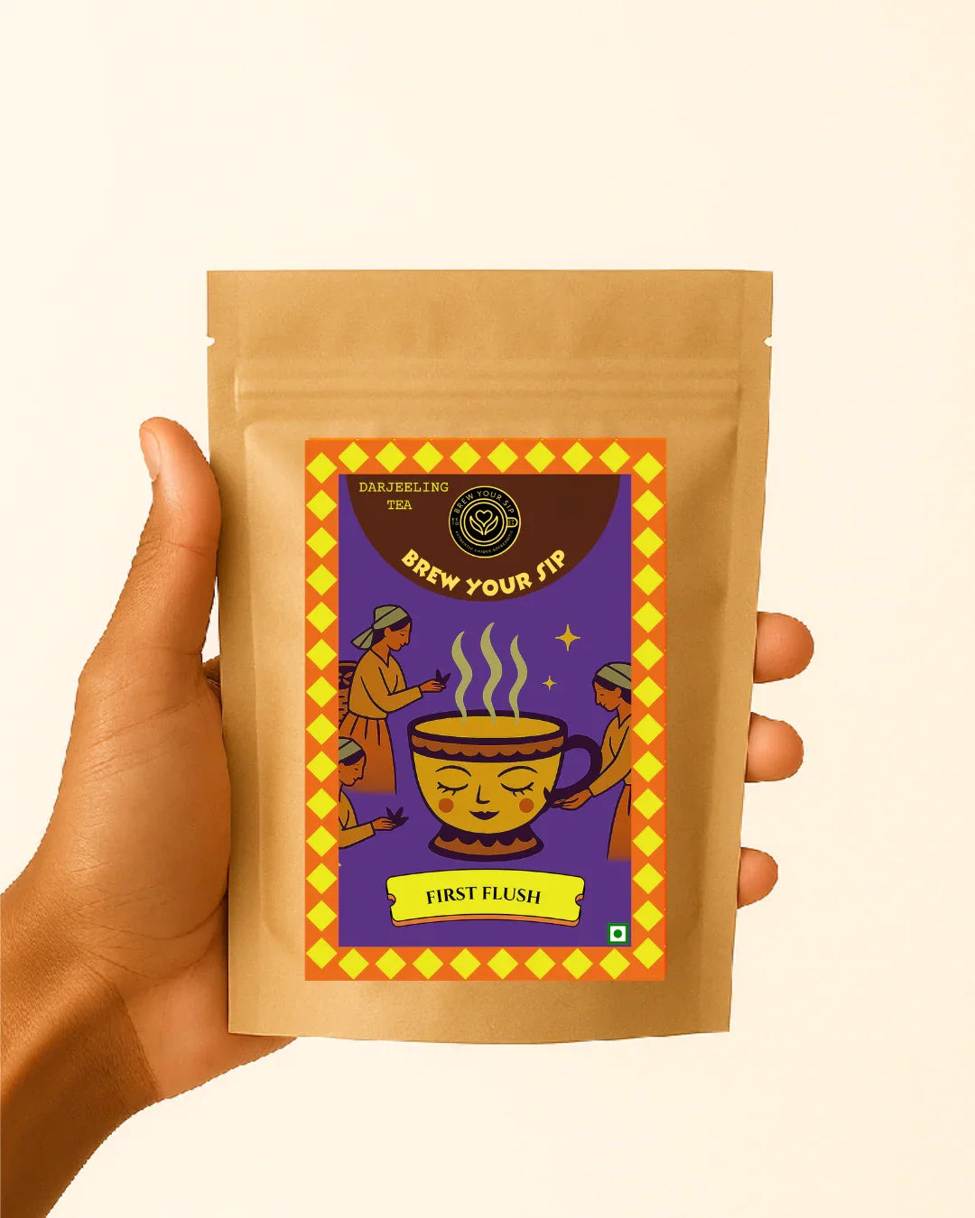Hand holding light brown tea pouch by Brew Your Sip