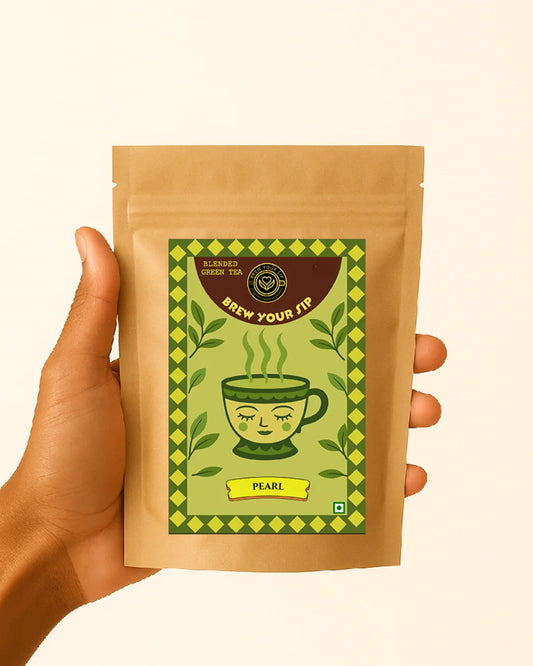 Tea package with a green label held by a hand on a beige background