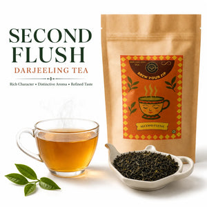 Brew Your Sip Second Flush Darjeeling tea pouch with dark curled leaves in a white dish and a glass cup of amber tea