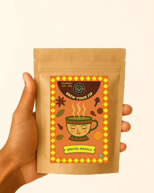Hand holding a brown package of Special Masala tea with a decorative label.