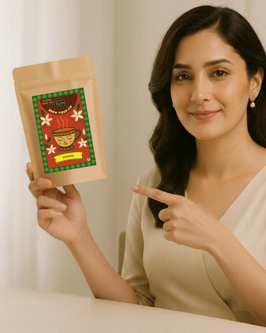 Woman holding and pointing to a product package with a decorative design.