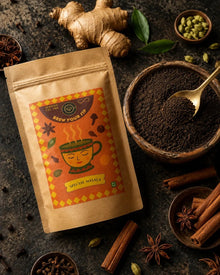 CTC chai sampler pouch with ginger, cardamom, cinnamon and loose CTC granules on a dark surface, view 4