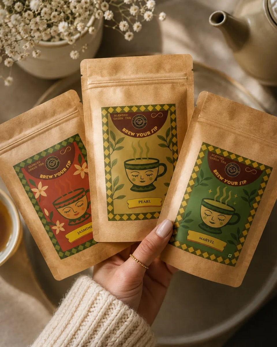 Hands holding three Brew Your Sip green tea sampler pouches